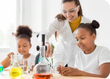 a teacher helping two kids with a science experiement