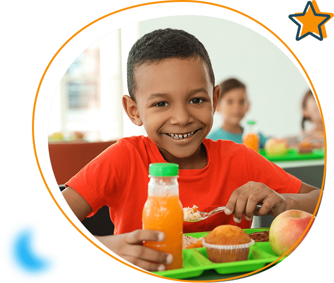 a child smiling while at a meal